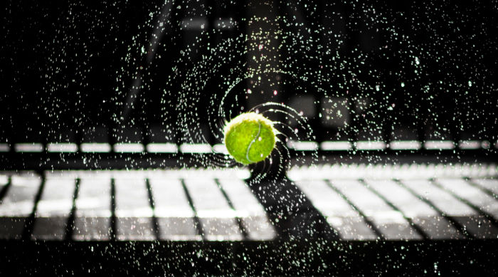 Tennis ball rolling and rotating with water